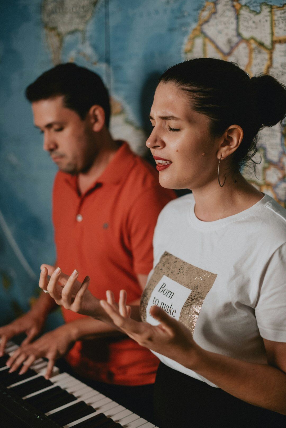 Two colleagues collaborating and discussing notes at a laptop in an office